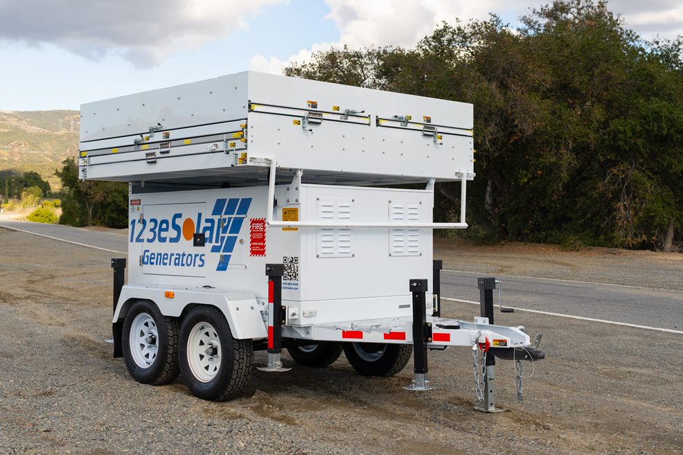 123-SG-4S82 — Ten panels stowed on a tandem-axle trailer, ready to tow to a site with no grid.