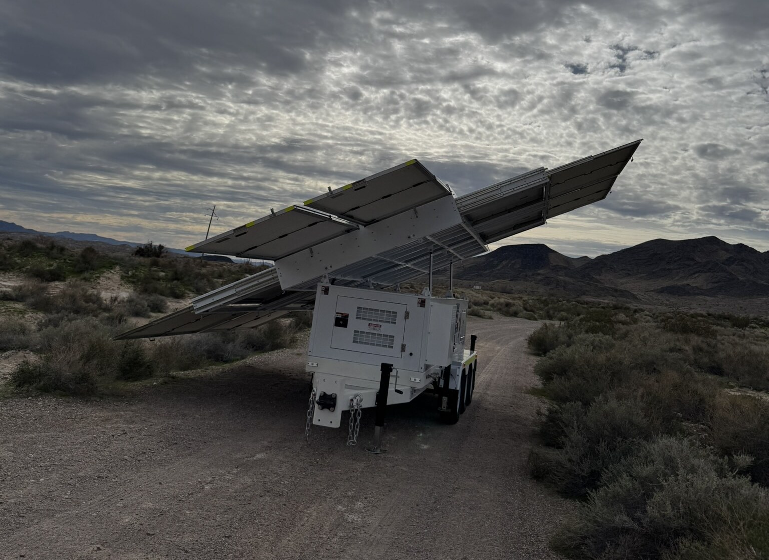 123-SG-7S42 — The array raised against the evening sky: 7.36 kW of panels on one trailer.