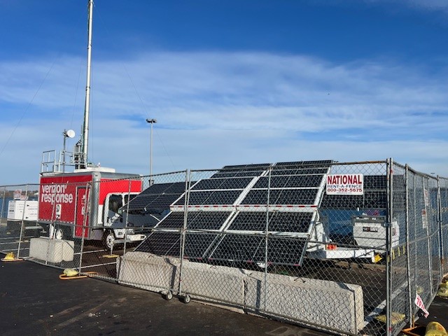 123-STG-71S62 — A 123eSolar Tri-Brid™ with its array raised beside the Verizon Response cell on wheels, MetLife Stadium parking lot
