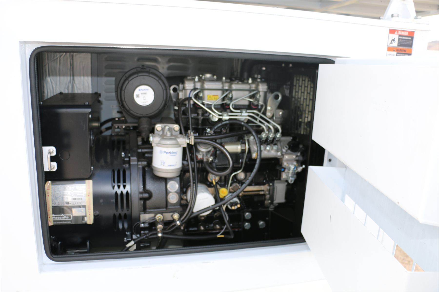 123-STG-72D62 — The EPA Tier 4 Final diesel behind its service door, fed from a 120-gallon tank.