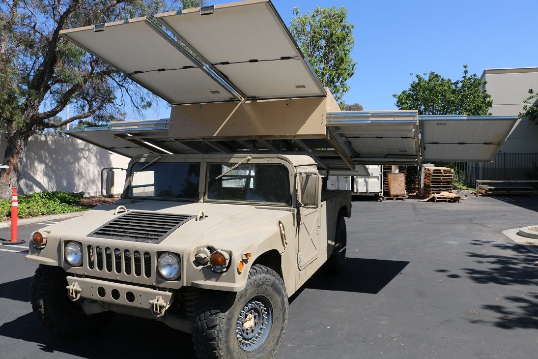 The M998 HMMWV with its solar array unfolded over the cab and cargo bed