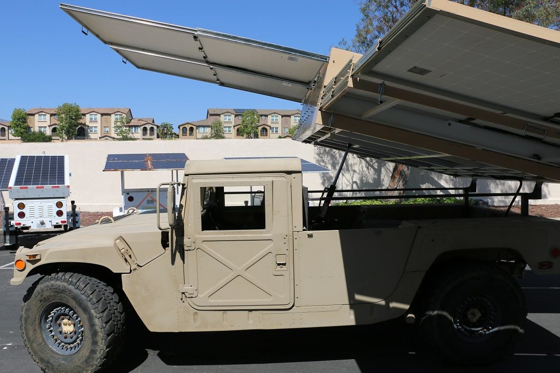 Panels raised on their frames above the cargo bed, seen from the driver’s side