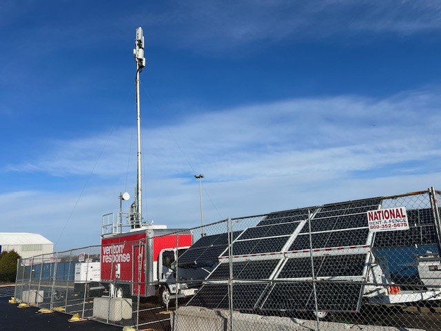 The cell on wheels with its mast up, and the Tri-Brid™ array powering it, MetLife Stadium parking lot