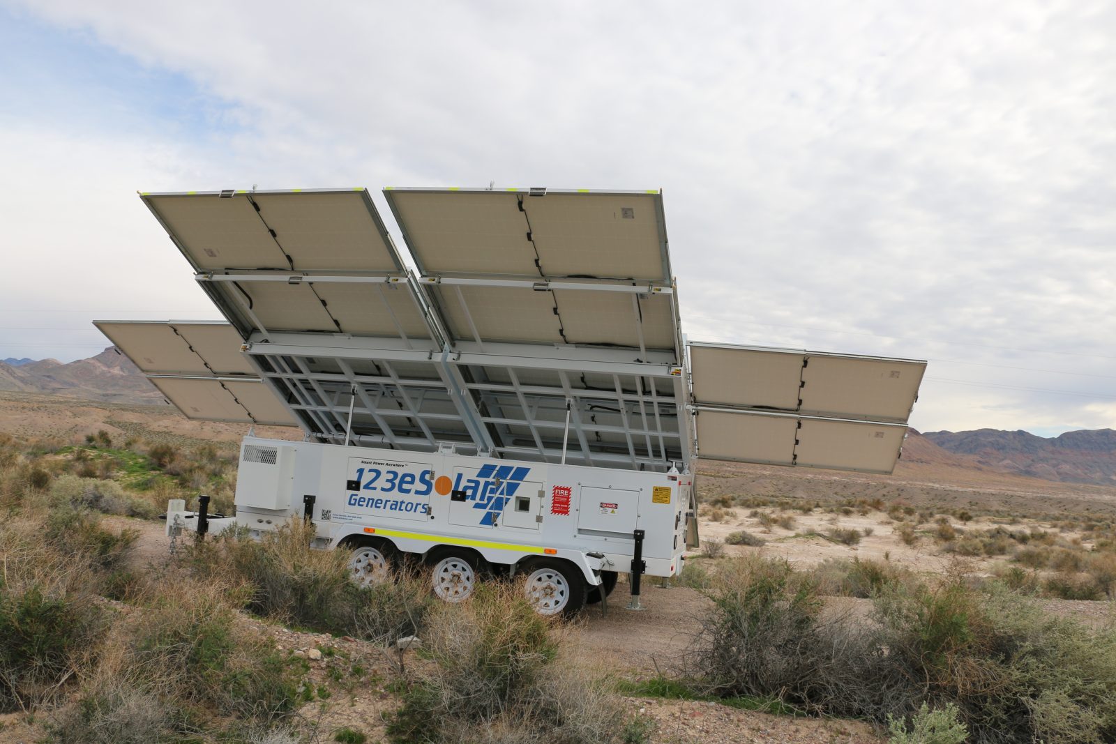 A 123eSolar Tri-Brid™ generator in the desert with its full solar array raised and tilted to the sun